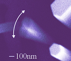 Electron micrograph of a NIST-grown nanowire with a high quality factor vibrating more than 1 million times per second. At lower right, a stationary nanowire shows the typical hexagonal shape of the gallium nitride structures.

Credit: S. Tanner, CU/JILA