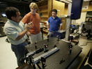 SOUTHEASTERN PATENT  From left, Southeastern Louisiana University physicist Sanchiro Yoshida explains points about his patented deformation detection instrument to student assistants Christopher W. Schneider and John A. Gaffney. The instrument, Southeastern's first patent, helps detect structural weaknesses in various materials. (Photo: Randy Bergeron, Southeastern Public Information Office)