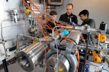 Timothee Pourpoint, center, a senior research scientist in Purdue's School of Aeronautics and Astronautics, works on pressure vessels and a coolant valve panel with doctoral students Tyler Voskuilen, left, and Milan Visaria. The work is part of research to develop a new hydrogen storage system for future cars and is being conducted at the Hydrogen Systems Laboratory. (Purdue News Service photo/David Umberger)