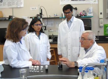 An Auburn University engineering research team works with a newly developed antimicrobial coating, which is made from a combination of lysozyme, a natural product with antimicrobial properties found in egg whites and human tears, with single-walled carbon nanotubes, which are strong, microscopic pieces of carbon. Pictured, left to right, are study leader and assistant professor Virginia Davis, postdoctoral fellow Dhriti Nepal, graduate student Shankar Balasubramanian and professor Aleksandr Simonian.