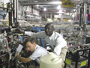 NIST materials scientists Cherno Jaye (r.) and Dan Fischer adjust a sample chamber for NIST's soft x-ray materials characterization beamline at the National Synchrotron Light Source.

Credit: NIST