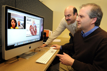 Regenstrief Center for Healthcare Engineering director Steven Witz, from left, and Purdue communications professor Bart Collins experiment with new technology that will be used to help design a telehealth model to promote patient learning and improve self-care. In this test, Witz and Collins are communicating via computer with Hannah Kim, a doctoral student in education technology, and Scott Schaffer, a Purdue professor of education technology. (Purdue News Service photo/David Umberger)