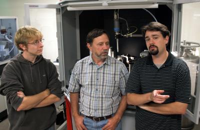 Graduate student Zachary Mensinger, left, talks with co-authors Lev N. Zakharov, center, and Darren Johnson in Zakharov's lab in the underground Lorry I. Lokey Laboratories at the University of Oregon.

Credit: Photo by Jim Barlow