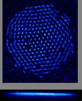 Under certain conditions, trapped beryllium ions form a hexagonal single-plane crystal. This crystal consists of about 300 ions that are spaced about 10 micrometers apart and are fluorescing (scattering laser light). An array of ions such as this might be used as a memory device in a quantum computer.

Credit: NIST
