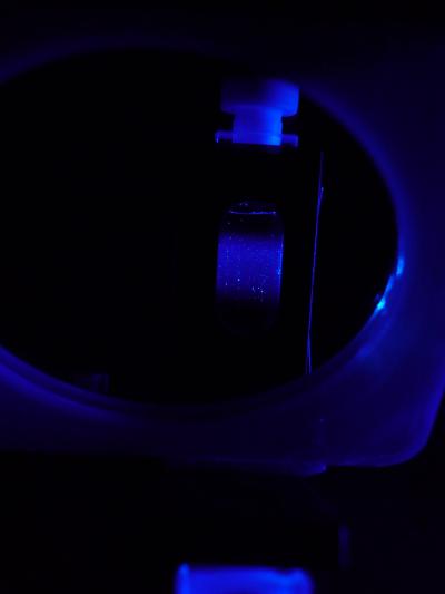 This is a suspension of nanoparticles in a quarz-glass cell exposed to ultra violet light. The nanoparticles emit deep-blue fluorescence.
