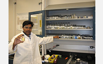 Sudipta Seal holds a bottle containing billions of ultra-small, engineered nanoceria