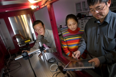 Ge Wang, far right, Virginia Tech director of the Virginia Tech-Wake Forest University School of Biomedical Engineering Sciences' biomedical imaging division, works in his nanoscale fabrication characterization research laboratory with Haiou Shen and Fang Liu of biomedical engineering.