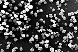 Kongs Plasma Nanoparticle Fabricator (PNF) converts sand-size grains of feedstock material (shown here) to nanoparticles very efficiently, generating no byproducts. 