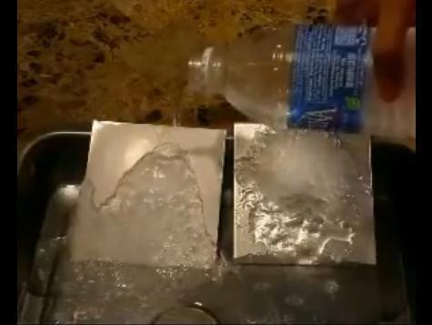 An aluminum plate glazed with Gao's superhydrophobic coating (left) repelling the supercooled water. For the uncoated plate (right), the water freezes on contact and ice accumulates. (Credit: Image courtesy of University of Pittsburgh)
