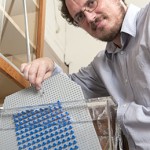 German Drazer, asst. prof. of ChemBE, shows how a LEGO set-up can explain forces in mircofluidic arrays. (Will Kirk/JHU)
