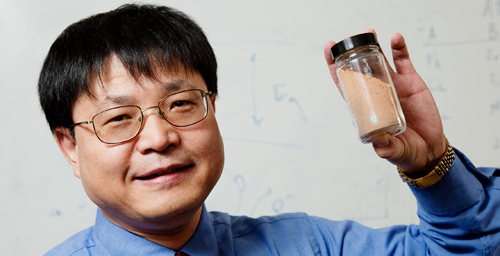 Jian Ku Shang, a professor of materials science and engineering, holds a sample of a new photocatalytic material that uses visible light to destroy harmful bacteria and viruses, even in the dark.
