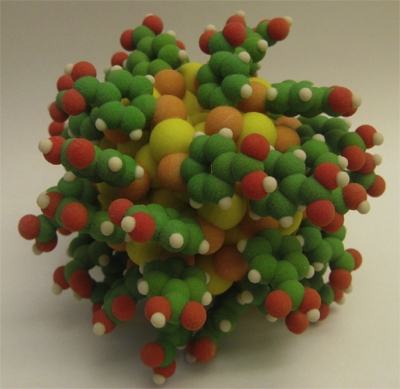Figure: An atomistic model of the Au102(p-MBA)44 particle. Gold:yellow, sulfur:orange, carbon:green, oxygen:red, hydrogen:white