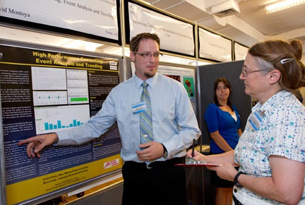 Bruce Gale of High Performance Computing Systems discusses his research with Student Symposium judge Georgia Pedicini.