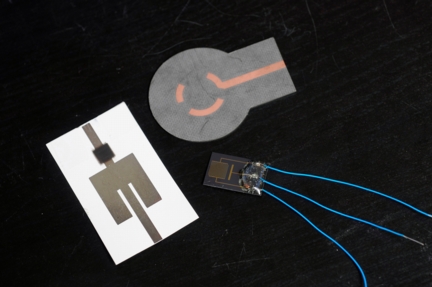 Sensor3 -- Pictured here are three wireless devices that use carbon nanotubes (CNTs) to achieve high sensitivity to ammonia. At left is a patch antenna, inkjet-printed on photographic paper, with the CNTs shown in black. At top center is an omni-directional segmented loop antenna on a soft substrate, designed for potential 5.8 GHz RFID integration. At bottom right is an inter-digitated capacitor on silicon substrate with CNT loading across the electrodes, being tested for its DC resistance. (Georgia Tech Photo: Gary Meek)