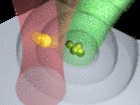 In a water drop, an aggregate of gold nanoparticles is heated by a green laser. As a consequence, sound waves are emitted which displace a nearby single nanoparticle that is kept in levitation by a red laser.