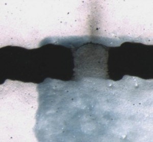 An optical microscopy image on of the channels in a printed OECT array.