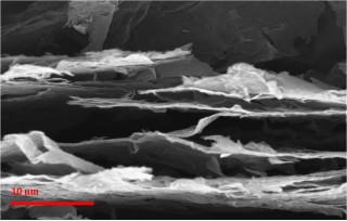 Engineering researchers at Rensselaer Polytechnic Institute made a sheet of paper from the worlds thinnest material, graphene, and then zapped the paper with a laser or camera flash to blemish it with countless cracks, pores, and other imperfections. The result is a graphene anode material that can be charged or discharged 10 times faster than conventional graphite anodes used in lithium (Li)-ion batteries for todays mobile phones, laptop and tablet computers, and even electric automobiles. The intentional imperfections, as seen in this scanning electron micrograph, are critical for the devices ability to quickly accept or discharge large amounts of energy.
