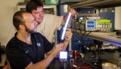Wake Forest University physics professor David Carroll works with graduate student Greg Smith on new FIPEL lighting technology.