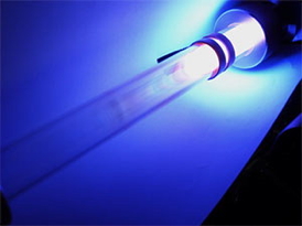 Light is emitted from excited argon gas atoms flowing through the glass tube of a plasma reactor. The plasma is a reactive environment used to produce silicon nanocrystals that can be applied to inexpensive, next-generation electronics.