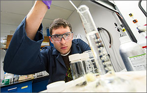 NREL intern Jonah Richard adds solvent to polymers that will be added to nanotubes in order to single out species of them.
Credit: Dennis Schroeder