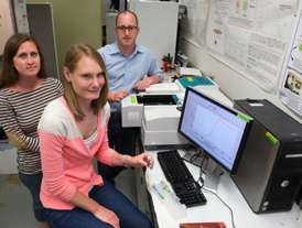 Associate Professor Mathew M. Maye supervises graduate students Colleen Alexander, left, and Kristen Hamner in his chemistry lab.