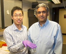 From left: Sungjae Ha and Anantha Chandrakasan demonstrate the chip in the Nanomechanics Laboratory.
Photo: Patricia Sampson/EECS