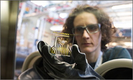 NREL scientist Arrelaine Dameron works with an Electrical Calcium Test (e-Ca) glass card in a glovebox. The test measures water permeating through the thin-film barriers that guard cell phones, TVs, OLEDs, and PV cells.
Credit: Dennis Schroeder