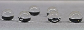 Water droplets on a metal substrate coated with NANOMYTE SuperCN Plus, showing a high contact angle (> 150).