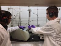 Postdoctoral research associate Monojit Bag (left) and graduate student Tim Gehan (right) synthesize polymer nanoparticles for use in organic-based solar cells being made at the University of Massachusetts Amherst-based energy center. Deep purple nanoparticles are forming in the small glass container above Gehan's left hand.

Credit: UMass Amherst