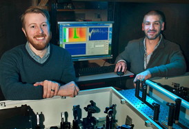 Postdoctoral fellow Erik Busby and Matt Sfeir with optical equipment they used to study charge carrier production in organic photovoltaic polymers at Brookhaven Lab's Center for Functional Nanomaterials.
