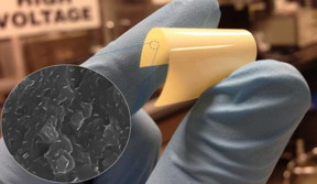 Researcher holds flexible dielectric material. Pull out shows boron nitride nanosheets.
CREDIT: Qing Wang, Penn State