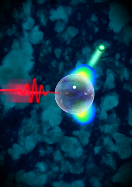Directional electron acceleration on glass nanospheres. A femtosecond laser pulse (coming from the left) hits a glass nanosphere. The light releases electrons (green) from the group of atoms. Picture: Martin Dulovits/woogieworks