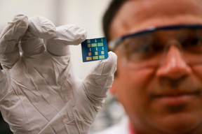 University of Utah materials science and engineering associate professor Ashutosh Tiwari holds up a substrate layered with a newly discovered 2-D material made of tin and oxygen. Tiwari and his team have discovered this new material, tin monoxide, which allows electrical charges to move through it much faster than common 3-D material such as silicon. This breakthrough in semiconductor material could lead to much faster computers and mobile devices such as smartphones that also run on less power and with less heat.
CREDIT: Dan Hixson/University of Utah College of Engineering
