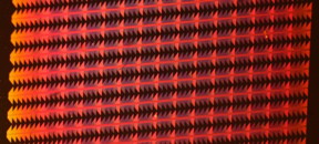 Silicon chip with nanoscale copper plasmonic components.

Image courtesy