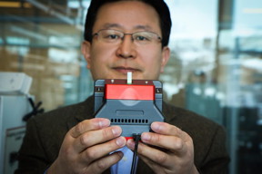 University of Utah materials science and engineering professor Ling Zang holds up a prototype handheld detector his company is producing that can sense explosive materials and toxic gases. His research team developed a new material for the detector that can sense alkane fuel, a key ingredient in such combustibles as gasoline, airplane fuel and homemade bombs.
CREDIT: Dan Hixson/University of Utah College of Engineering