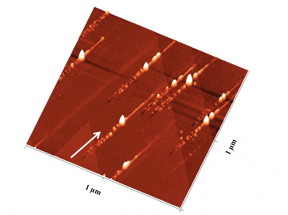 Nanostructures on a crystal after ion bombardment: Trenches with nanohillocks on either side are created. At the impact site, a particularly large nanohillock is formed.
CREDIT: TU Wien