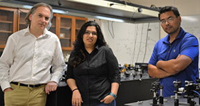 Boldizsar Janko, left, Rusha Chatterjee and Masaru Kuno stand in the Kuno lab at Notre Dame