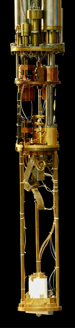 Scientist at Cornell University (USA) used this custom-built microscope - a Spectroscopic Imaging Scanning Tunneling Microscope - to monitor electron-activity in ironbased superconductors. The microscope is 1 meter tall. At the top equipment can lower the temperature to -273 Celcius, a fraction above absolute zero. Photo: Cornell University/J.C. Seamus Davis. (Graphic image, red & blue, on black)