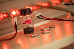 Professor Zhi Chunyi from City University of Hong Kong and his team developed battery-like electrochemical Nb2CTx MXene electrodes, the black material inside the bottle. The silver “buttons” next to the bottle are batteries and at the back is the battery testing system.

CREDIT
City University of Hong Kong