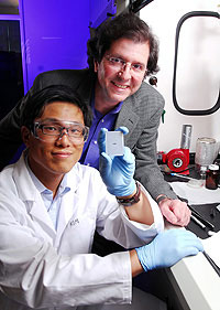 Georgia Tech researchers Joe Perry and Philseok Kim display a capacitor array device made with a barium titanate nanocomposite.