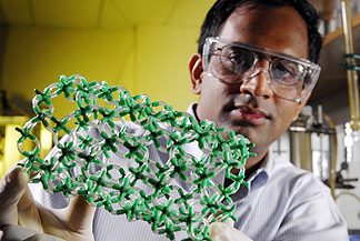 Sankar Nair, an assistant professor in the Georgia Tech School of Chemical and Biomolecular Engineering, holds a model showing the structure of metal oxide nanotubes he is developing. The research could lead to a technique for precisely controlling the dimensions of the structures.

Georgia Tech Photo: Gary Meek