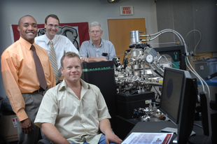 Laura Shill, UA Office of Photography 

Rich Martens, seated, an atom probe microscopist within the Central Analytical Facility, joins, from left, Drs. Mark Weaver, Greg Thompson and Mike Bersch within the facility.