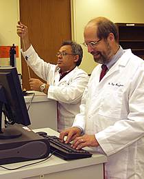 Dr. Ray Baughman (right) and Dr. Anvar Zakhidov work with a magnetometer at UT Dallas.