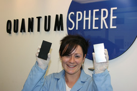 Kimberly McGrath, PhD, Director of Fuel Cell R&D, QuantumSphere, Inc., holds QSI-Nano NiFe coated electrode (left) vs. standard stainless steel electrode for hydrogen generation through water electrolysis.