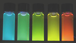 Brightly glowing vials of highly luminescent, water soluble quantum dots produced by the new NIST microwave process span a wavelength range from 500 to 600 nm.

Credit: NIST