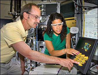 Michael White and Melissa Patterson review an image of a molybdenum sulfide nanocluster.