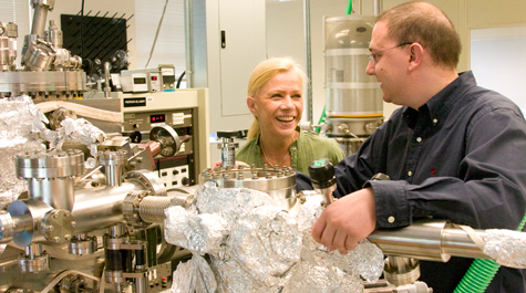VMEC Associate Professor Ale Lukaszew (left) works with César Clavero, a post-doctoral research associate in applied science, in their lab in McGlothlin-Street Hall. Clavero says that the aluminum foil covering parts of their vacuum pump makes an excellent insulator. He recently won an Outstanding Young Researcher Award from the American Vacuum Society.
