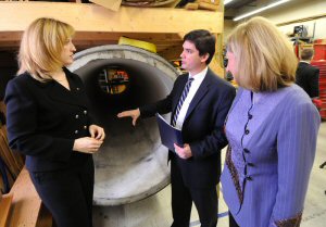 Brian Mergelas (centre), President and CEO of the Pressure Pipe Inspection Company (PPIC), shows Natural Resources Minister Lisa Raitt (left) and Sustainable Development Technology Canada (SDTC) President and CEO Vicky Sharpe (right) around the company's facility. SDTC and the Government of Canada announced today $53 million in funding to 16 emerging Canadian clean technologies. (MARKETWIRE PHOTO/Derek Oliver, CP)