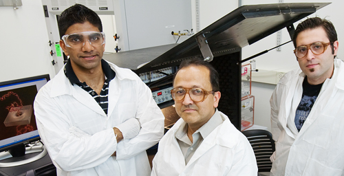 Rashid Bashir, a Bliss Professor of electrical and computer engineering and of bioengineering, center, led the researchers who developed a new solid-state nanopore sensor. He is flanked by graduate students Murali Venkatesan, left, and Sukru Yemenicioglu.

Photo by L. Brian Stauffer.