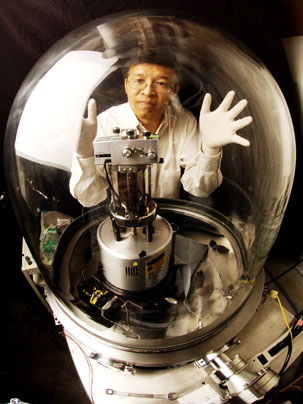 Professor Gang Chen with the vacuum chamber used in this research.